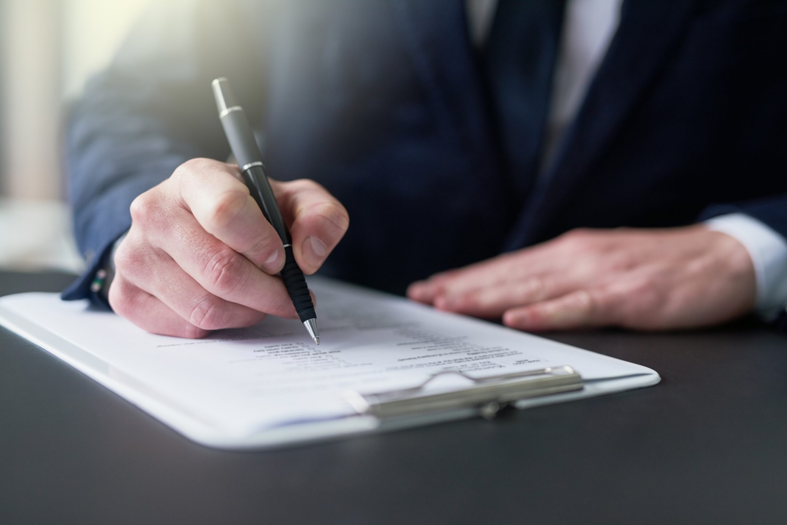 Businessman,,Hand,And,Writing,On,Document,For,Signature,For,Legal